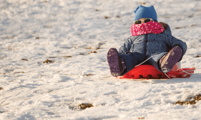 Little girl sledding